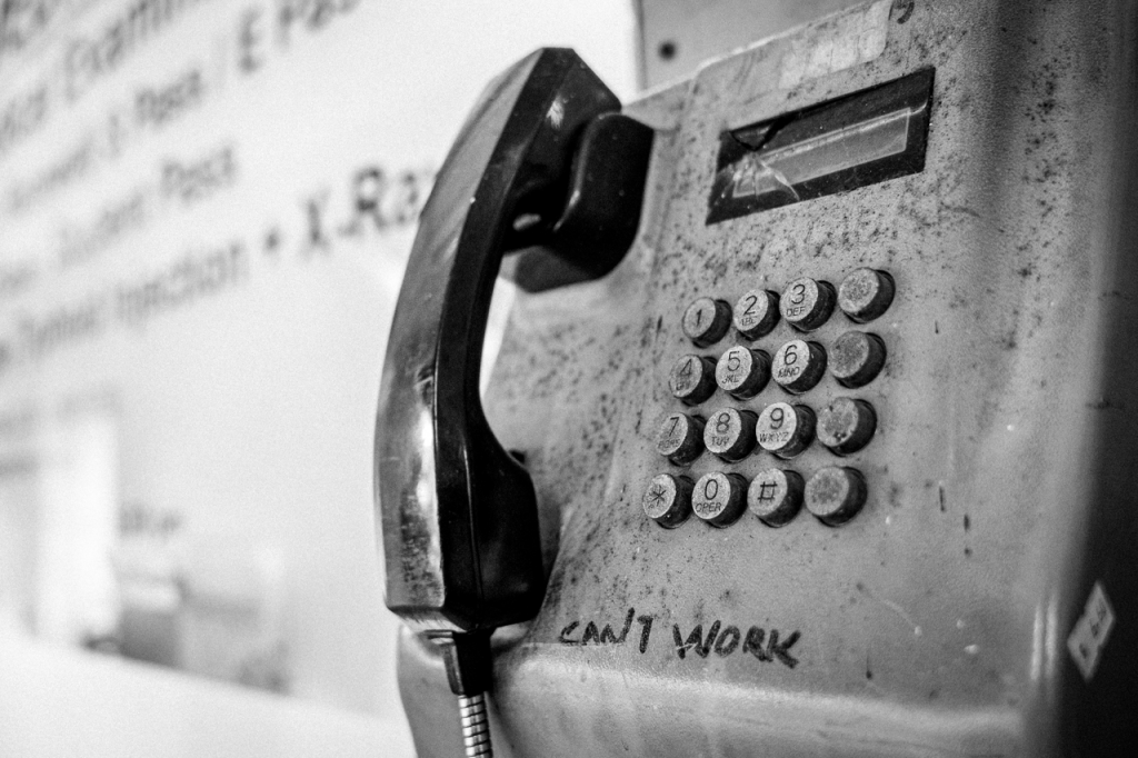 Phone booth with words: "Can't work." Clearly, not everyone is ambitious.