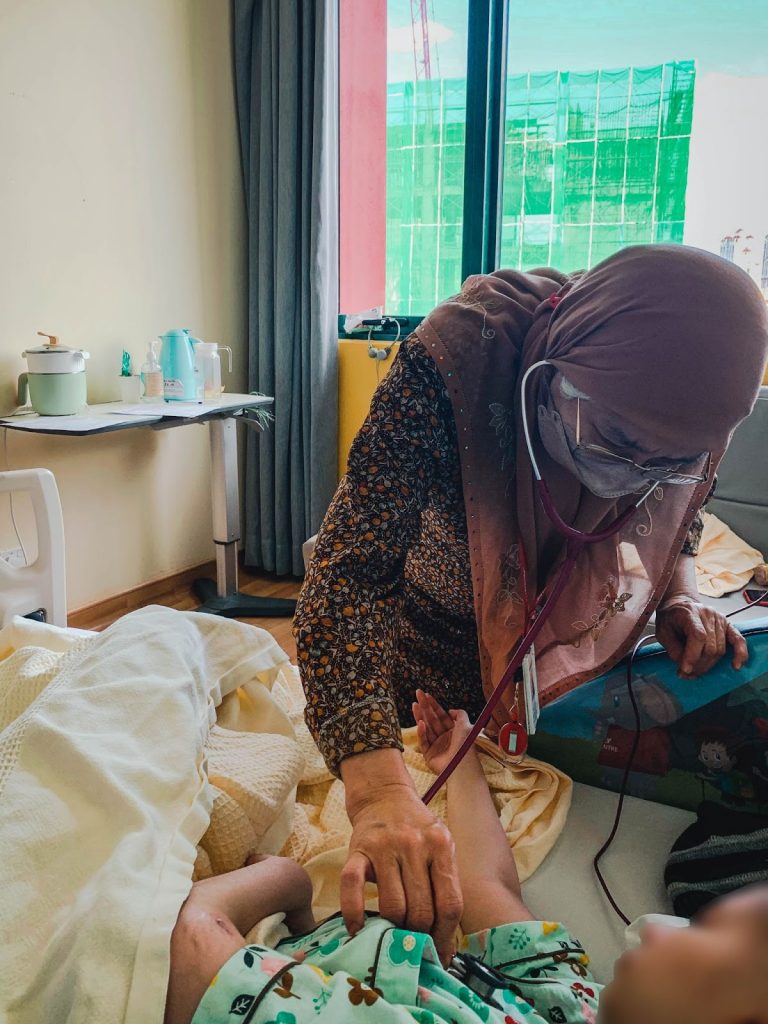 Oncologist Doctor Eni checking in on one of her patients with cancer