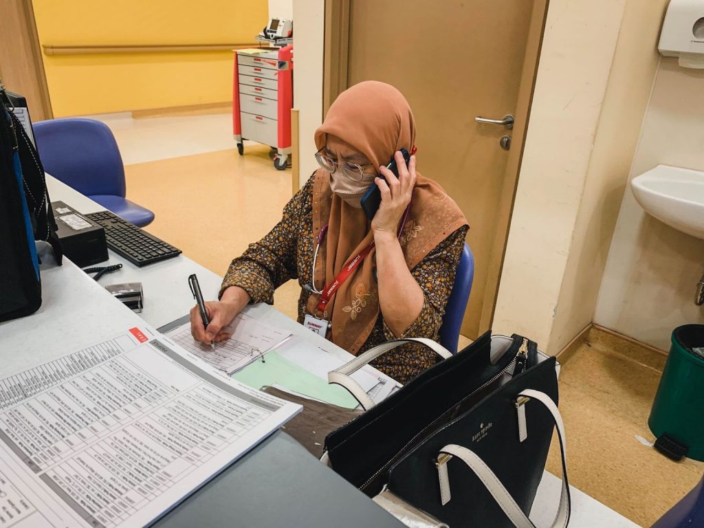 Oncologist Doctor Eni on a phone call at work.