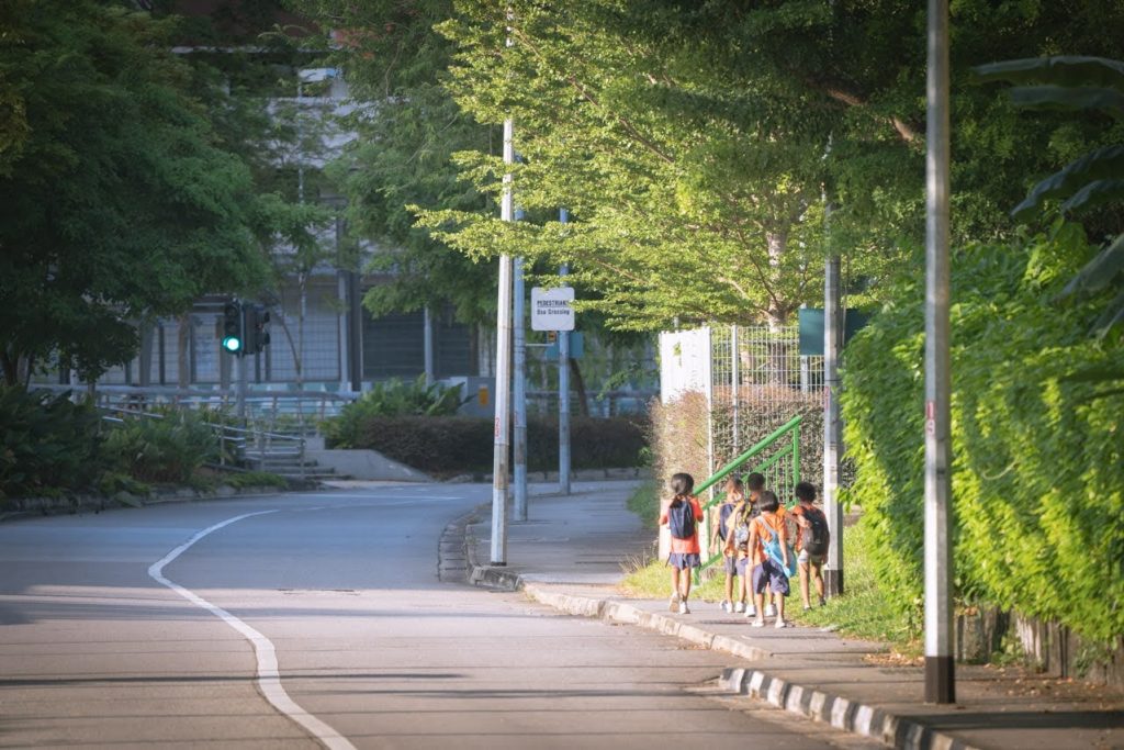 Image of school children walking down the road together.